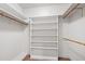 Bright walk-in closet with custom shelving and rods for optimal storage in a well-organized space at 2720 Townedge Ct, Raleigh, NC 27612