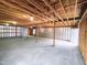 Large, unfinished basement with exposed wooden beams and concrete floor at 305 N Webb St, Selma, NC 27576