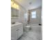 White tiled bathroom featuring a combined tub and shower at 305 N Webb St, Selma, NC 27576