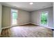 Bedroom showcasing neutral walls, wood floors, and a door leading to the exterior balcony at 305 N Webb St, Selma, NC 27576