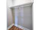 Empty closet with white trim and a rod, offering ample space for storage and organization at 305 N Webb St, Selma, NC 27576
