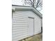 Garage exterior with a white door and siding, offering a clean and functional space at 305 N Webb St, Selma, NC 27576