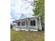 Quaint single-Gathering home showing the exterior with a inviting front porch and traditional architecture at 305 N Webb St, Selma, NC 27576