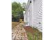 Quaint white home featuring a brick walkway and a small wooden porch on a nicely landscaped lot at 305 N Webb St, Selma, NC 27576