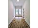 Hallway featuring hardwood floors leading to double glass doors, creating a bright and open feel at 305 N Webb St, Selma, NC 27576