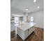 Bright, open kitchen with a large island featuring stone countertops and an undermount sink at 305 N Webb St, Selma, NC 27576