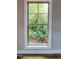 View of a blossoming garden through a large window, bringing nature indoors and enhancing the room's aesthetic at 305 N Webb St, Selma, NC 27576
