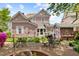 Charming backyard with brick patio, outdoor seating, lush landscaping, and a small outbuilding at 308 S Pearl St, Rocky Mount, NC 27804