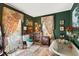 Vintage bathroom featuring green wallpaper, clawfoot tub, and ornate decor at 308 S Pearl St, Rocky Mount, NC 27804