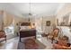 Charming bedroom with floral wallpaper, dark wood furniture, and natural light at 308 S Pearl St, Rocky Mount, NC 27804