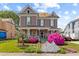 Charming two-story home featuring beautiful pink flowers, a cozy front porch, and manicured lawn at 308 S Pearl St, Rocky Mount, NC 27804