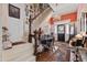 Elegant foyer with staircase, chandelier, vintage sewing machine and Persian rug accenting the hardwood floors at 308 S Pearl St, Rocky Mount, NC 27804