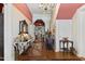 Inviting foyer with hardwood floors, chandelier, vintage sewing table and runner leading into the home at 308 S Pearl St, Rocky Mount, NC 27804