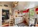 Charming kitchen with bright white cabinets, unique decor and access to a deck at 308 S Pearl St, Rocky Mount, NC 27804