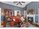 Vintage living room featuring patterned wallpaper, ornate fireplace, and antique furniture, exuding old-world charm at 308 S Pearl St, Rocky Mount, NC 27804