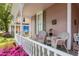 Inviting front porch with seating, decorative railings, and a view of the neighborhood at 308 S Pearl St, Rocky Mount, NC 27804