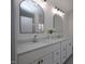 Double vanity bathroom boasts white cabinets, marble counters, and modern fixtures at 3244 Marcony Way, Raleigh, NC 27610