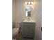 Charming half bathroom boasts beadboard cabinetry and stylish arched mirror at 3244 Marcony Way, Raleigh, NC 27610