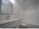 Bathroom featuring a modern vanity, toilet, and shower-tub combination, all in pristine white at 3244 Marcony Way, Raleigh, NC 27610
