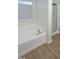 Bathroom with soaking tub features modern fixtures and a separate glass shower at 3244 Marcony Way, Raleigh, NC 27610