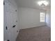 Bright bedroom with neutral carpet and window, complemented by a modern ceiling light and a closet with white doors at 3244 Marcony Way, Raleigh, NC 27610