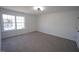 Spacious bedroom with neutral carpet and paint, a bright window, and modern lighting creating a comfortable atmosphere at 3244 Marcony Way, Raleigh, NC 27610