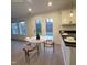 Dining area with light colored walls and flooring with a view to backyard through french doors at 3244 Marcony Way, Raleigh, NC 27610