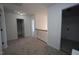 Upstairs hallway with neutral walls, carpet, and a wrought iron banister leading to various rooms, including a bathroom at 3244 Marcony Way, Raleigh, NC 27610