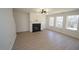 Bright living room features a fireplace, modern light fixture, and ample natural light from the many surrounding windows at 3244 Marcony Way, Raleigh, NC 27610