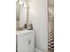 Bathroom vanity with white cabinets, a sink with a modern faucet, and a shower with a striped curtain at 3332 Cheswick Dr, Raleigh, NC 27609