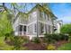 Lovely two-story home with a screened porch, lush landscaping, and classic architectural details at 3332 Cheswick Dr, Raleigh, NC 27609