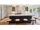 Modern kitchen featuring a large island with seating, sleek countertops, and contemporary lighting fixtures at 3332 Cheswick Dr, Raleigh, NC 27609