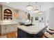 Bright kitchen features a large island, stainless steel appliances, and ample custom cabinetry with designer lighting at 3332 Cheswick Dr, Raleigh, NC 27609