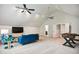 Spacious living room featuring high ceilings, ceiling fans and a comfortable blue sofa at 3332 Cheswick Dr, Raleigh, NC 27609