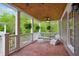 Cozy covered porch with brick flooring, comfortable seating, and views of the surrounding greenery at 3332 Cheswick Dr, Raleigh, NC 27609
