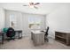 Home office/bedroom with ceiling fan, carpet, and large window for natural light at 361 W Copenhaver Dr, Clayton, NC 27527