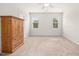 Spacious bedroom featuring neutral carpet and a large wooden cabinet and plenty of natural light at 361 W Copenhaver Dr, Clayton, NC 27527