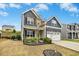Attractive two-story home with stone accents, a two-car garage, and well-maintained landscaping at 361 W Copenhaver Dr, Clayton, NC 27527