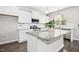 Bright kitchen features white cabinetry, granite countertops, stainless steel appliances, and a center island at 361 W Copenhaver Dr, Clayton, NC 27527