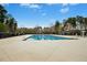 Community pool surrounded by mature trees offers a refreshing escape at 361 W Copenhaver Dr, Clayton, NC 27527