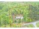 Aerial view of a house with property boundary outlined in red; home has mature trees and surrounding woods at 3954 Piney Grove Church Rd, Siler City, NC 27344
