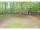 A spacious backyard with mature trees has a shed for storage and backs to surrounding woods at 3954 Piney Grove Church Rd, Siler City, NC 27344