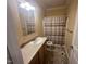 Neutral bathroom featuring a shower with glass doors, and a single sink vanity with ample countertop space at 3954 Piney Grove Church Rd, Siler City, NC 27344