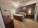 Spacious main bedroom features neutral carpet, a ceiling fan, and a large bed at 3954 Piney Grove Church Rd, Siler City, NC 27344