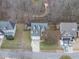 Aerial view of a home with well-manicured lawns, mature trees, and proximity to scenic boardwalk at 416 Collinsworth Dr, Clayton, NC 27527