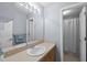 Bright bathroom featuring a large mirror, vanity with sink, and a separate shower area at 416 Collinsworth Dr, Clayton, NC 27527