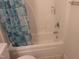 This bathroom features white tiling and a blue patterned shower curtain at 4502 Pale Moss Dr, Raleigh, NC 27606