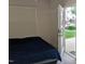 A bright bedroom is presented with an exterior door allowing access to a patio at 4502 Pale Moss Dr, Raleigh, NC 27606