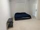 This bedroom features neutral walls and carpet and a door leading to the exterior at 4502 Pale Moss Dr, Raleigh, NC 27606