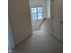 Neutral hallway with carpet and staircase leading to the second floor, with natural light at 4502 Pale Moss Dr, Raleigh, NC 27606